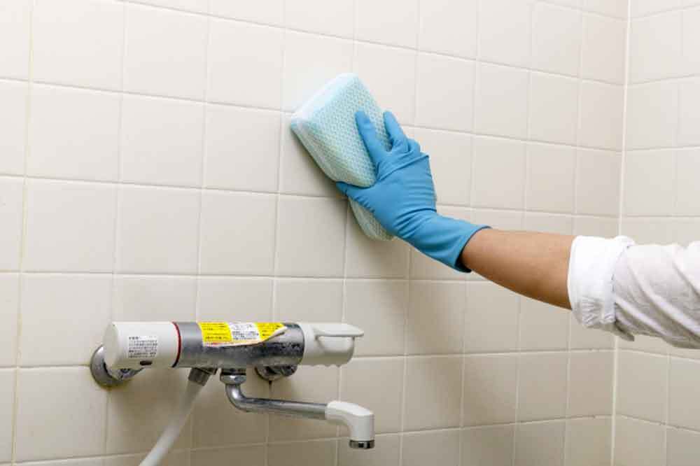 浴室を掃除する女性